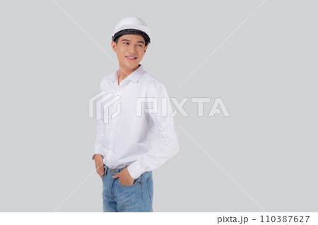 Portrait young asian man is engineer wearing helmet standing and smiling with confident isolated. 110387627