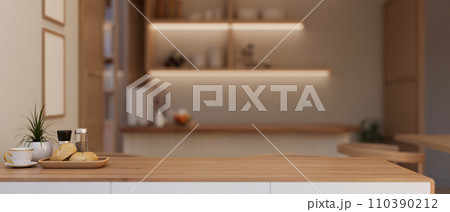 Copy space for displaying your product on a wooden dining table in a modern, luxury dining room. 110390212