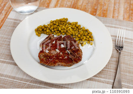 Popular all over the world dish of appetizing fried beef steak, subject with green peas Popular all over the world dish of appetizing fried beef steak, subject with green peas 110391093