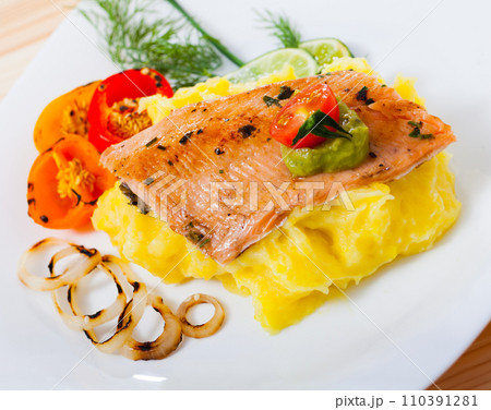 Deliciously fried trout fillet with mashed potatoes, peppers and greens Deliciously fried trout fillet with mashed potatoes, peppers and greens 110391281