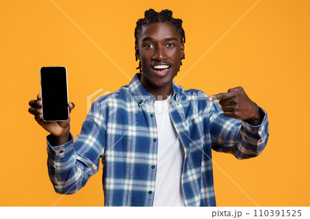 Excited Black Guy Demonstrating Smartphone With Blank Screen At Camera 110391525