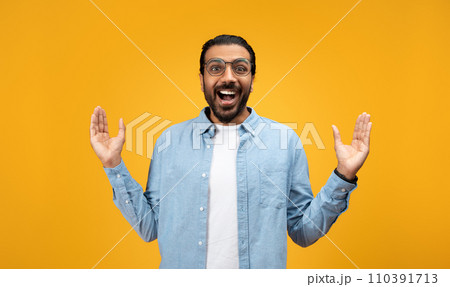 Exuberant man with a beard and glasses, arms raised in a welcoming gesture Exuberant man with a beard and glasses, arms raised in a welcoming gesture 110391713