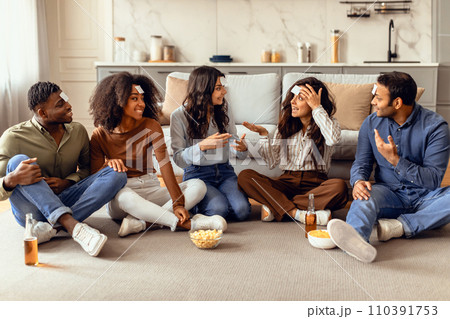 Diverse students engaged in fun games playing Guess Who indoor 110391753