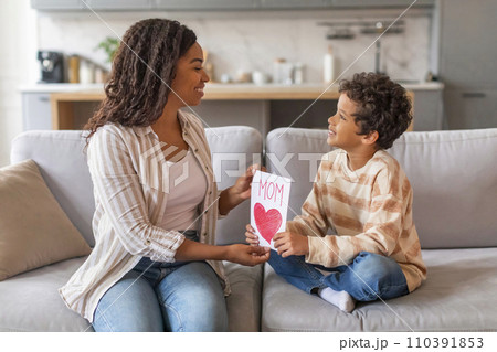 Mother's Day. Son Giving Greeting Card To His Happy Mom At Home Mother's Day. Son Giving Greeting Card To His Happy Mom At Home 110391853
