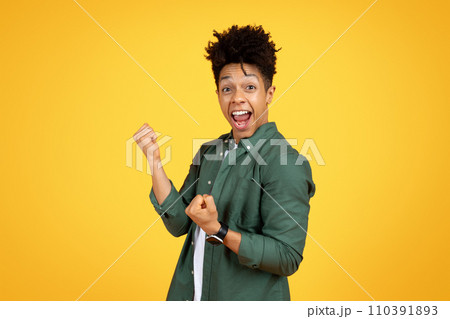 Excited young african american guy celebrating success, clenching fist Excited young african american guy celebrating success, clenching fist 110391893