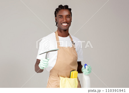 Cleaning Services. Handsome Black Cleaner Man Posing With Detergents And Washing Tools 110391941
