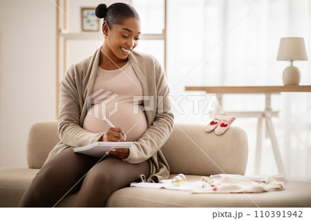 Pregnant black woman getting ready for the maternity hospital 110391942