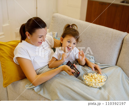 Mother Daughter Leisure. Happy Woman And Her Female Child Watching Tv Together 110392197