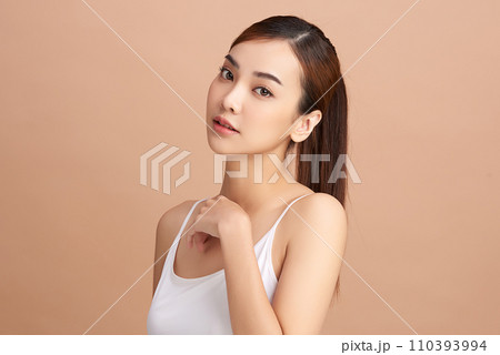 Beautiful young asian woman with clean fresh skin on beige background, Face care, Facial treatment, Cosmetology, beauty and spa, Asian women portrait. Beautiful young asian woman with clean fresh skin on beige background, Face care, Facial treatment, Cosmetology, beauty and spa, Asian women portrait. 110393994