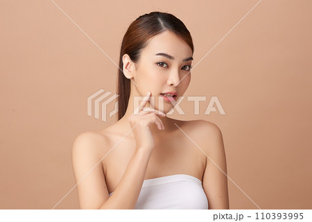 Beautiful young asian woman with clean fresh skin on beige background, Face care, Facial treatment, Cosmetology, beauty and spa, Asian women portrait. Beautiful young asian woman with clean fresh skin on beige background, Face care, Facial treatment, Cosmetology, beauty and spa, Asian women portrait. 110393995