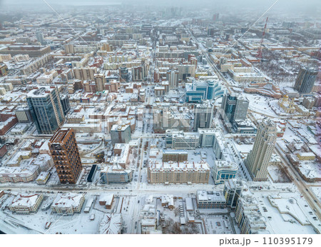 Yekaterinburg aerial panoramic view at Winter in cloudy day. Ekaterinburg is the fourth largest city in Russia located in the Eurasian continent on the border of Europe and Asia. Yekaterinburg aerial panoramic view at Winter in cloudy day. Ekaterinburg is the fourth largest city in Russia located in the Eurasian continent on the border of Europe and Asia. 110395179