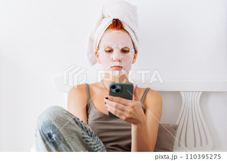 Skin care beauty cosmetic mask young redhead woman 110395275