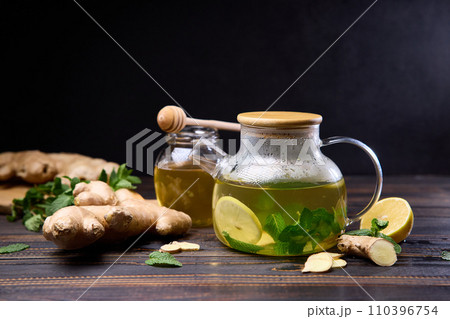 natural organic herbal tea in glass teapot on a wooden table 110396754