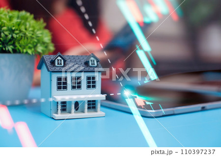 House model on the background of the stock market. The concept of buying a house.Real estate concept 110397237