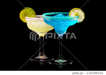 Set of Blue Curacao cocktails garnished with a lime isolated on black background 110399102