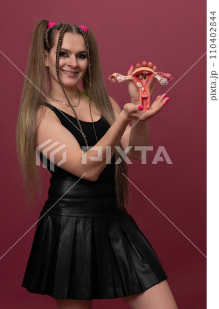 woman holds model of female reproductive system in the hands. Help and care concept 110402844