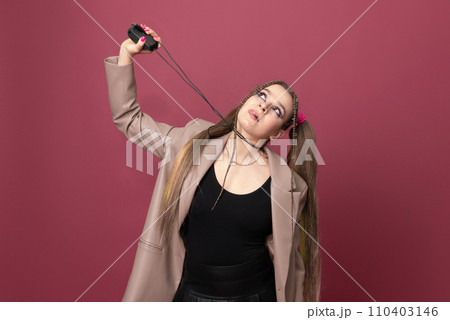 Beautiful young woman with lots of computer cables over her head, peeking behind a computer mouse Beautiful young woman with lots of computer cables over her head, peeking behind a computer mouse 110403146