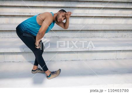 Man on the stairs doing stretching Man on the stairs doing stretching 110403780