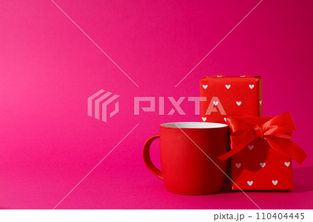 Red cup with a gift on a beautiful background 110404445