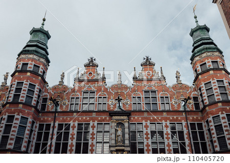 View of the Great Armoury building in Gdansk. The building is richly decorated. There building has many spikey towers. Renaissance building View of the Great Armoury building in Gdansk. The building is richly decorated. There building has many spikey towers. Renaissance building 110405720