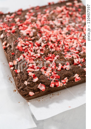 Cooling freshly baked peppermint brownies with chocolate peppermint chips on a kitchen counter. 110407597