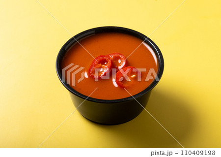 Spicy chili sauce in a bowl on yellow background Spicy chili sauce in a bowl on yellow background 110409198