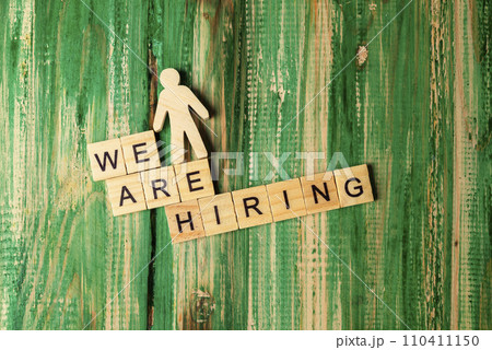Wooden figure and wooden cubes with We Are Hiring letters Wooden figure and wooden cubes with We Are Hiring letters 110411150