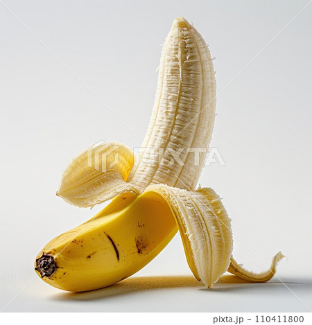 Half peeled ripe banana, isolated on white background Half peeled ripe banana, isolated on white background 110411800
