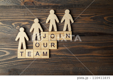 Wooden figures and wooden cubes with Join Our Team letters on a wooden table Wooden figures and wooden cubes with Join Our Team letters on a wooden table 110411835