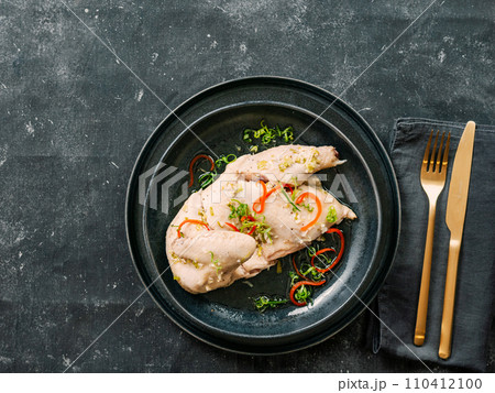 Sous Vide Chicken with spices. Boiled chicken sous-vide on black plate. Sous-vide is culinary method of long-term cooking 110412100
