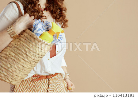 Stylish woman in blouse and shorts on beige Stylish woman in blouse and shorts on beige 110413193