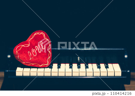 red heart on piano. music background 110414216
