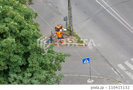 Workers installing a new street lamp post. Workers installing a new street lamp post. 110415132