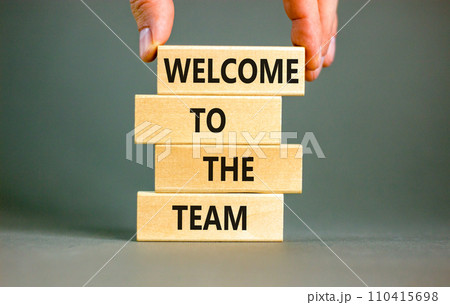 Welcome to the team symbol. Concept words Welcome to the team on wooden block. Beautiful white table white background. Businessman hand. Business, motivational and welcome to the team concept. Welcome to the team symbol. Concept words Welcome to the team on wooden block. Beautiful white table white background. Businessman hand. Business, motivational and welcome to the team concept. 110415698