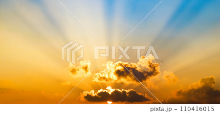 Bright sunrise on blue sky. Wide photo. Bright sunrise on blue sky. Wide photo. 110416015