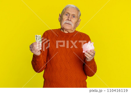 Poor senior old man insufficient amount of money, holding piggybank and one dollar banknote crisis 110416119