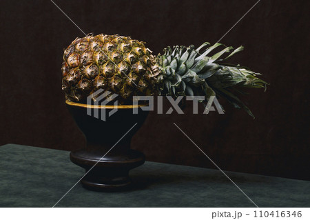 Ripe pineapple close-up on a dark background 110416346