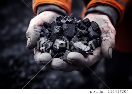 Coal mining in mine. Coal in hands of miner worker. Metallurgical coal for steel. Coal mining in mine. Coal in hands of miner worker. Metallurgical coal for steel. 110417204