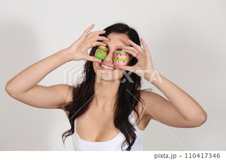 Beautiful woman with marzipan Easter eggs Beautiful woman with marzipan Easter eggs 110417346