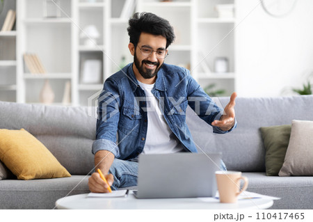 Distance Learning. Indian Male Attending Online Lesson, Having Video Call On Laptop Distance Learning. Indian Male Attending Online Lesson, Having Video Call On Laptop 110417465
