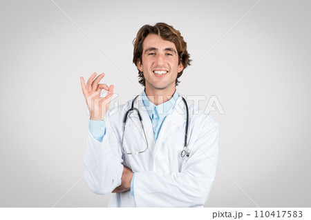 Doctor man giving 'okay' sign, symbolizing good health Doctor man giving 'okay' sign, symbolizing good health 110417583