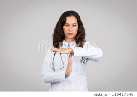 Doctor making timeout sign with serious face 110417649
