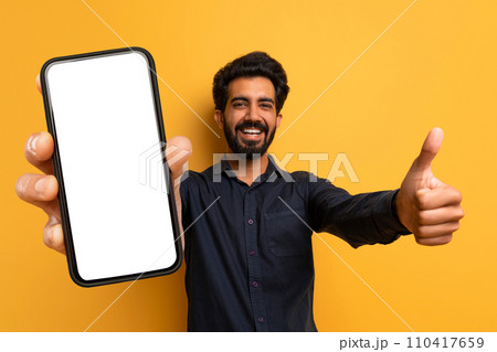 Cheerful Happy Indian Man Showing Thumb Up And Phone 110417659