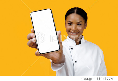Happy African American Female Chef Showing Blank Smartphone At Camera 110417741