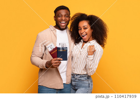 Joyful black couple with passports ready to travel 110417939
