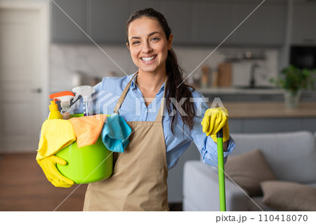 Confident cleaner with bucket and mop in a neat home Confident cleaner with bucket and mop in a neat home 110418070