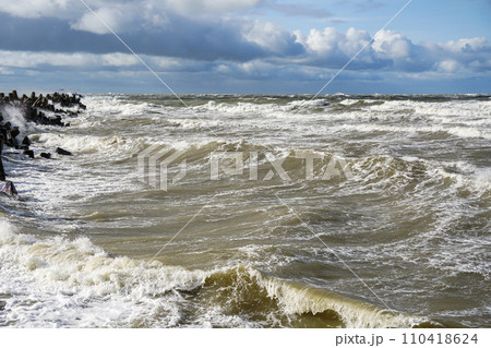 Stormy weather seascape, big waves with foam, low dark cumulus clouds, stormy sea view Stormy weather seascape, big waves with foam, low dark cumulus clouds, stormy sea view 110418624