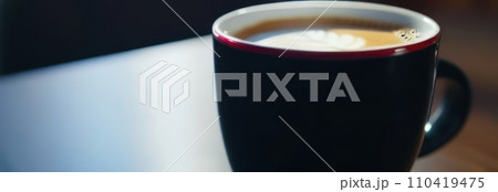 Cup of hot coffee on dark background.Long photo banner for website header design with copy space. Cafe menu concept idea background. Cup of hot coffee on dark background.Long photo banner for website header design with copy space. Cafe menu concept idea background. 110419475