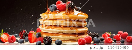 Stack of pancakes with berries. Advertising banner, web banner. Lush delicious pancakes with blueberries, raspberries and syrup for homemade breakfast. Lifestyle concept of food, cooking. Copy space. 110419490