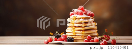 Stack of pancakes with berries. Advertising banner, web banner. Lush delicious pancakes with blueberries, raspberries and syrup for homemade breakfast. Lifestyle concept of food, cooking. Copy space. Stack of pancakes with berries. Advertising banner, web banner. Lush delicious pancakes with blueberries, raspberries and syrup for homemade breakfast. Lifestyle concept of food, cooking. Copy space. 110419491